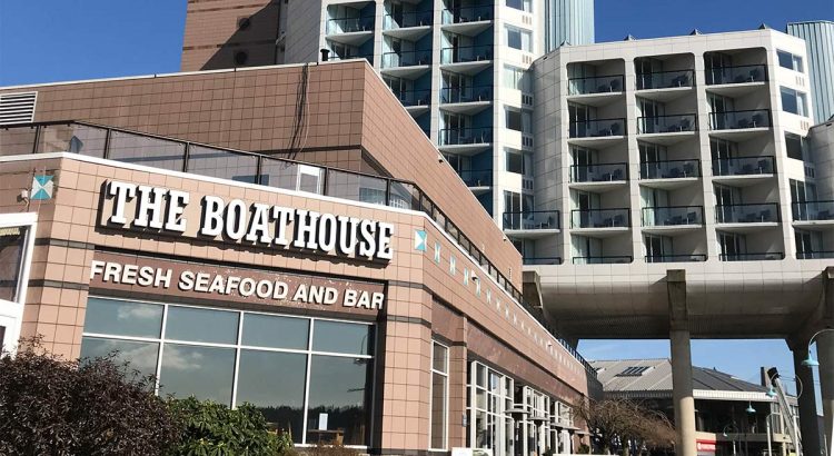 Boathouse restaurant with hotel in background