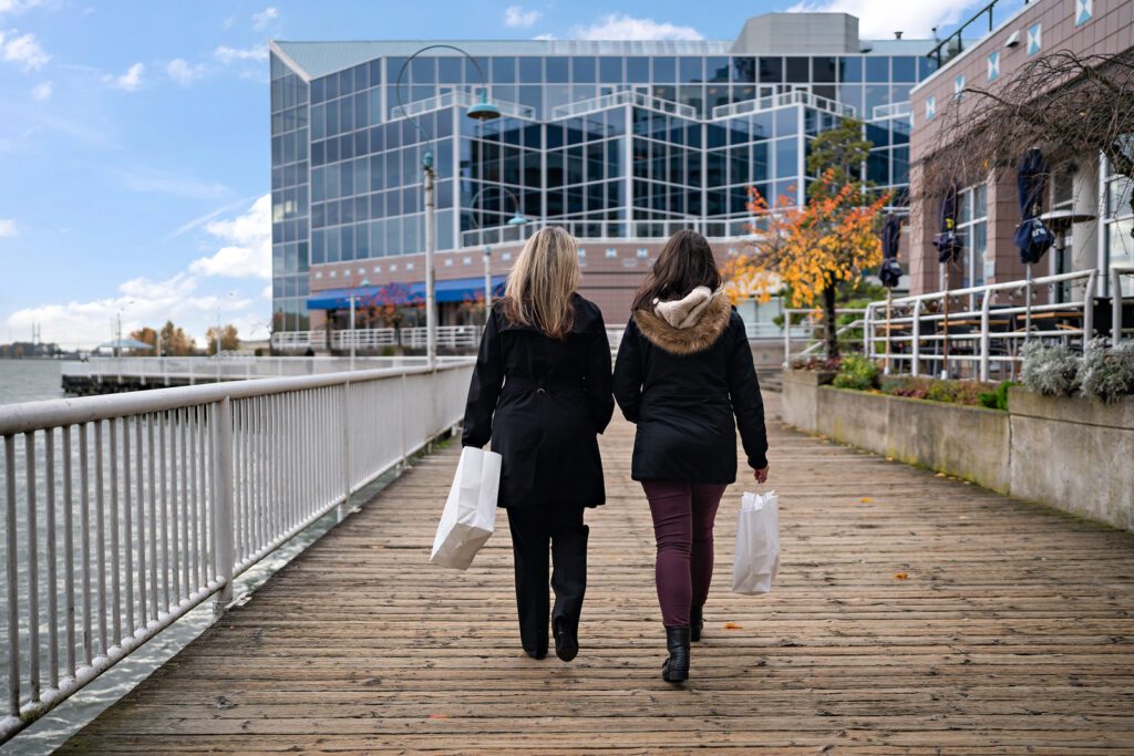 Friends walking at boardwalk in New Westminster, BC.
